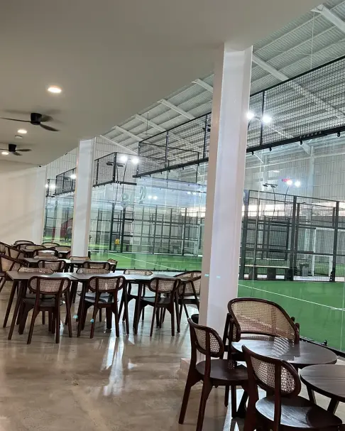 Rattan chairs and tables beside the courts