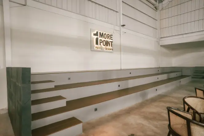 Tiered tribune seating facing the courts